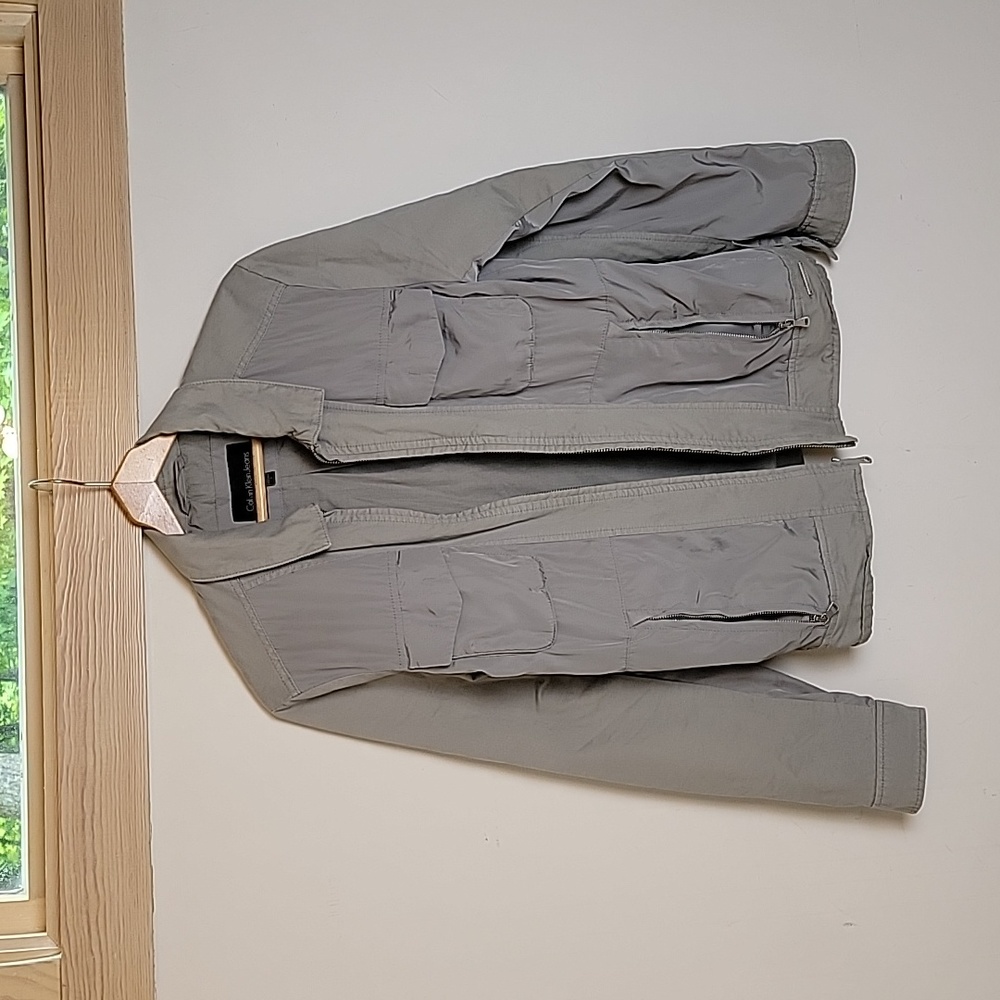 Calvin Klein Jeans Jacket. Silver color. Size small. Never worn.